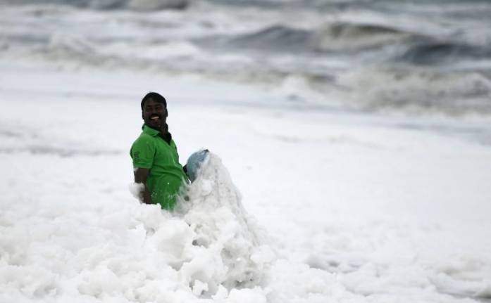 印度海岸污染泡沫遍布 渔民“雪地”中捕鱼
